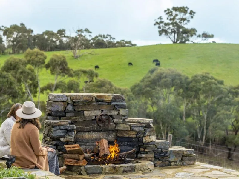 Person sitting by Outdoor Firepit